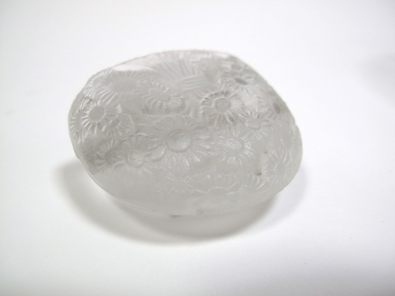 A Lalique Glass Paperweight, moulded with a bouquet of marguerite daisies to the front, with plain