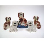 A Pair of XIX Century Staffordshire Pottery Spaniel Dogs, with red stippled bodies, 11.5cms high;