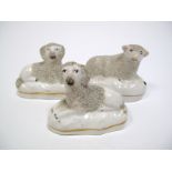 A Pair of XIX Century Staffordshire Pottery Recumbent Sheep, on oval bases, 6.5cms high; A Similar