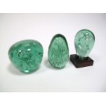 A Victorian Green Glass Dump, inset with foil floral inclusions, on square wooden base, 11.5cms