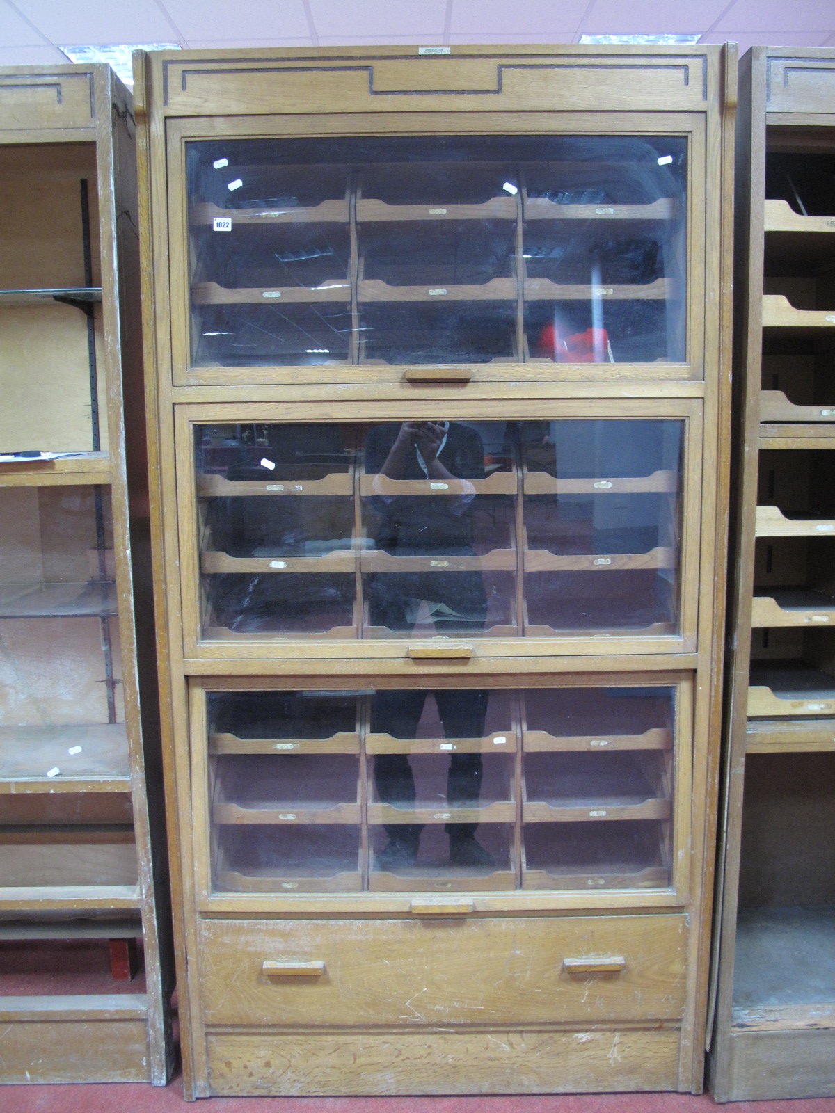 An Early - Mid XX Century Light Oak Haberdashery Shop Display Cabinet, bearing makers label "