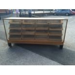 A Mid XX Century Light Oak Haberdashery Cabinet, with four banks of four waterfall drawers,