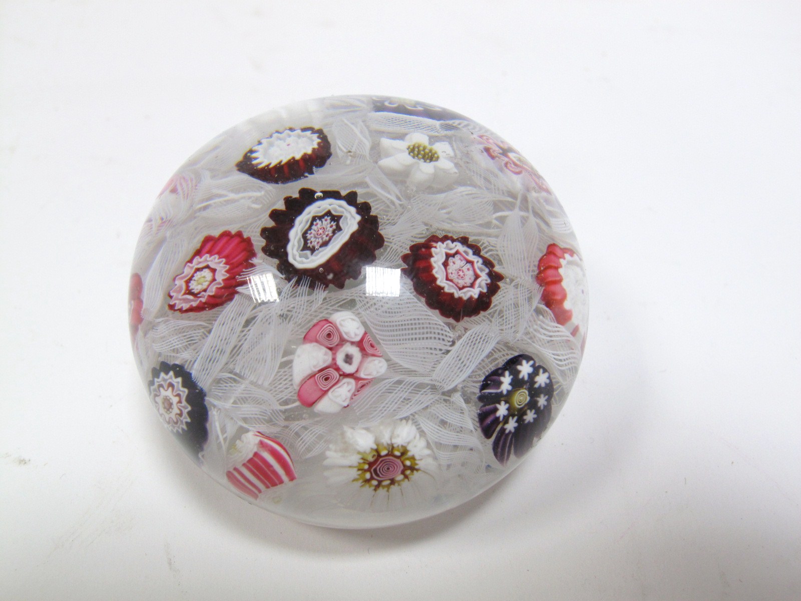 A XIX Century Domed Millefiore Paperweight, possibly Clichy, the central maroon pastry-mold cane