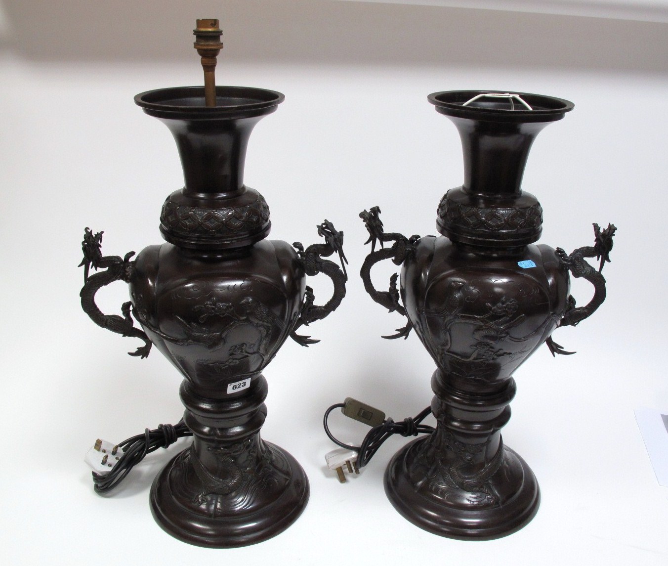 A Pair of Early XX Century Japanese Patinated Bronze Baluster Vases, relief cast with ornamental