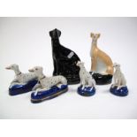 A XIX Century Staffordshire Pottery Greyhound, squatting on hind legs, on blue oval base, 17.5cms;