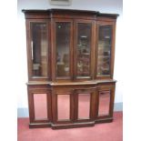 A Mid XIX Century Mahogany Breakfront Bookcase, the top with a stepped cornice and four bevelled