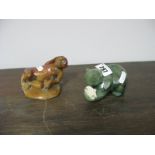 A Carved Green Hardstone Figure of a Bear with a Fish, and a brown hardstone figure of a monkey.