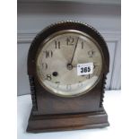 A 1920's Eight Day Oak Mantel Clock, with bead work and barley twist decoration, with circular dial,