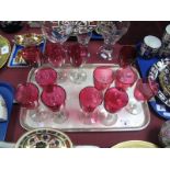 Twelve XIX Century Glass Wines, each with cranberry bowls, clear stem and circular footed base.