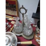 A Large Three Bottle Decanter Stand, fitted with three cut glass decanters (all lacking stoppers),