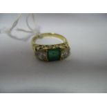 An 18ct Gold Emerald and Diamond Three Stone Ring, the central square emerald between two