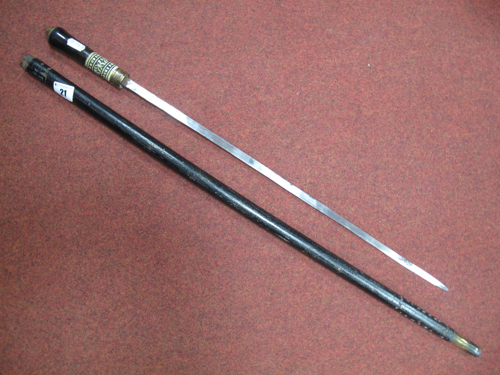 A XX Century Sword Stick of Indian Origin, with brass lion head pommel, circa 90cms long.