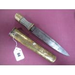 A Chinese Brass Dagger, white metal wirework grip, brass sheath decorated with a mythical beast