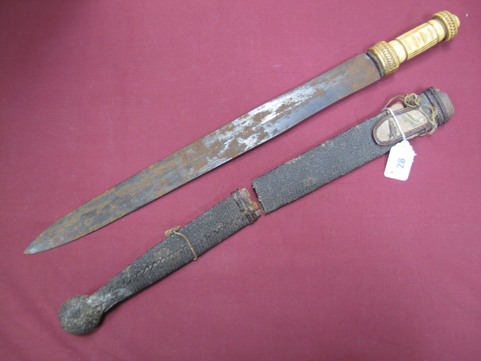 A XIX Century African Short Sword, 49cms, double edged blade to ivory carved handle, snakeskin