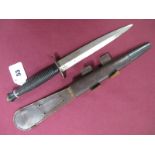 A Fairbairn-Sykes Fighting Knife, double sided 17cms blade, polished. Blackened brass grip, complete