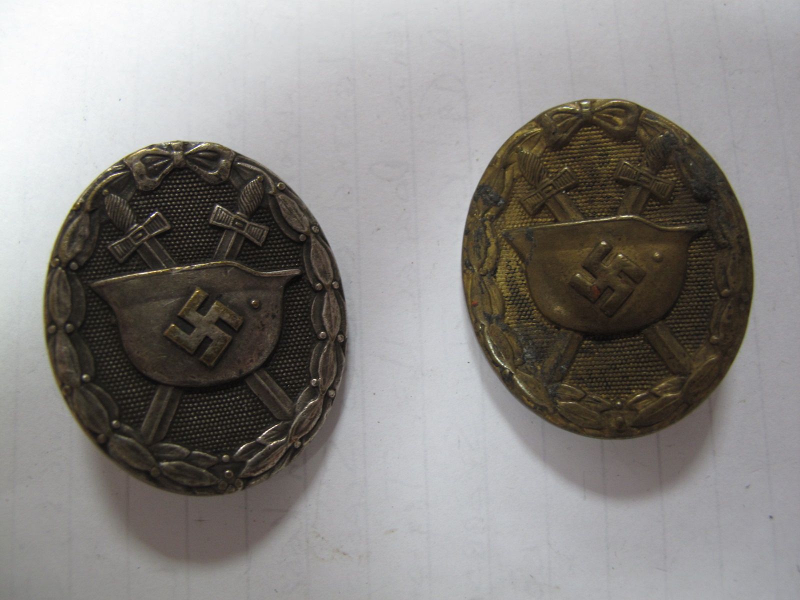 Two German Third Reich Wound Badges. One hollow tin, the other silver, (damaged).