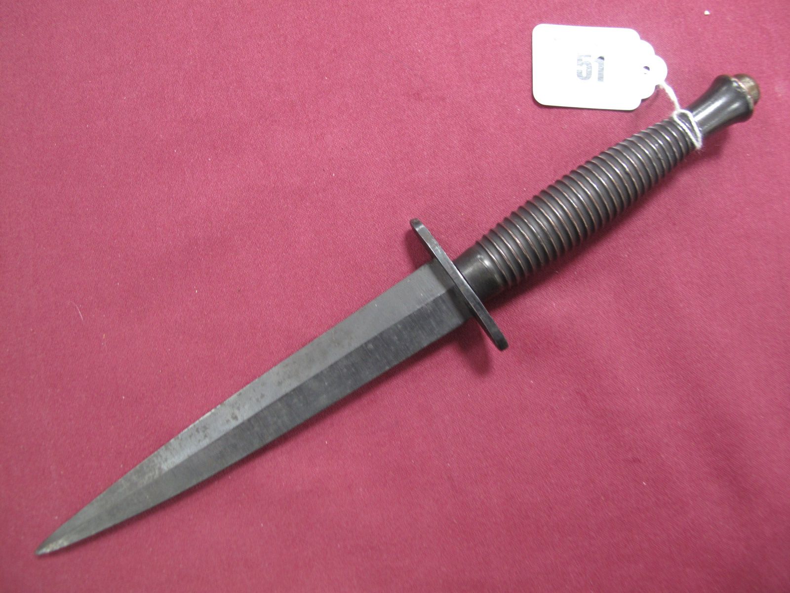 A Mid XX Century Fairburn-Sykes Fighting Knife, double edged 16cms blade, bent tip, blackened blade,