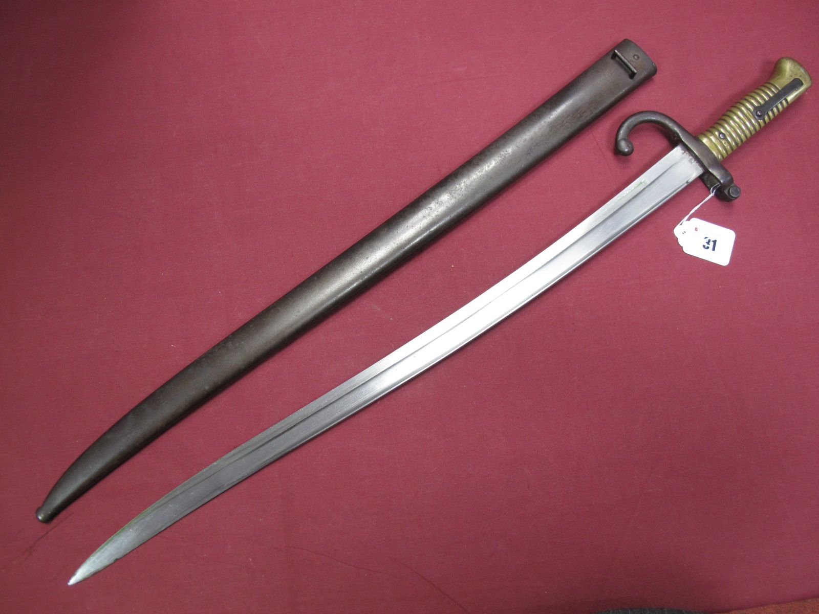 A Late XIX Century French Sabre Bayonet, with ribbed brass grip, No.97463, with scabbard. Scabbard