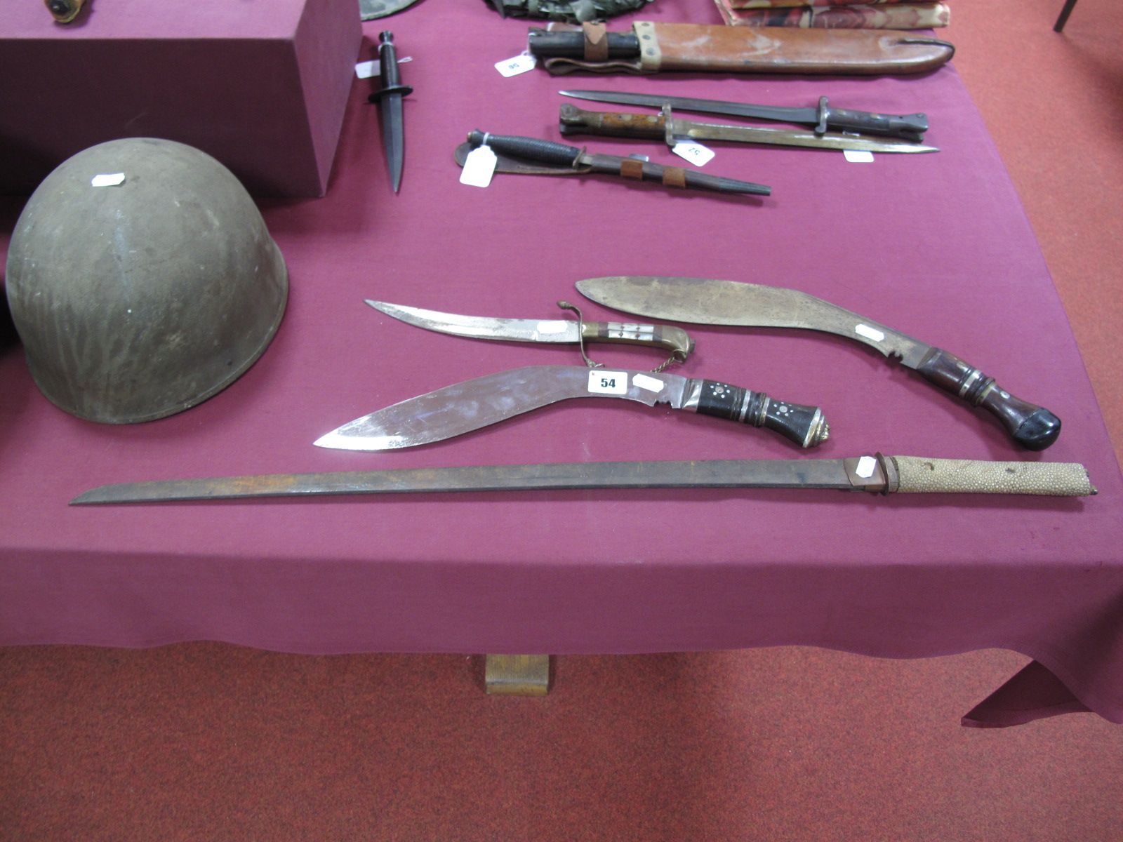 The Remnants of a XX Century Japanese Katana, two kukri without sheaths, and a decorative Persian