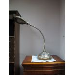 A 1920's Chrome Desk Top Table Lamp, with a chrome shade, on a circular base.