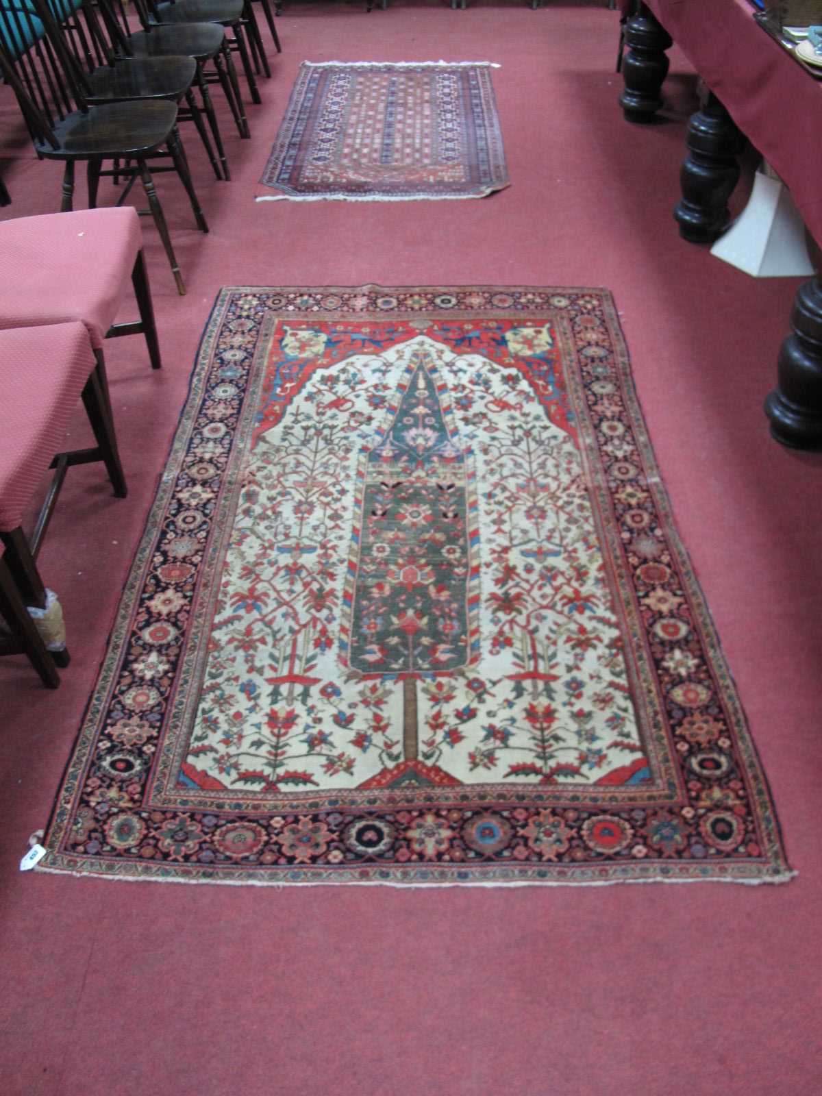 A Middle Eastern Rug, central depiction of the tree of life, stylised floral motifs on a cream