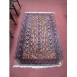 A Middle Eastern Tasseled Rug, centrally decorated with stylized geometric rows within multi