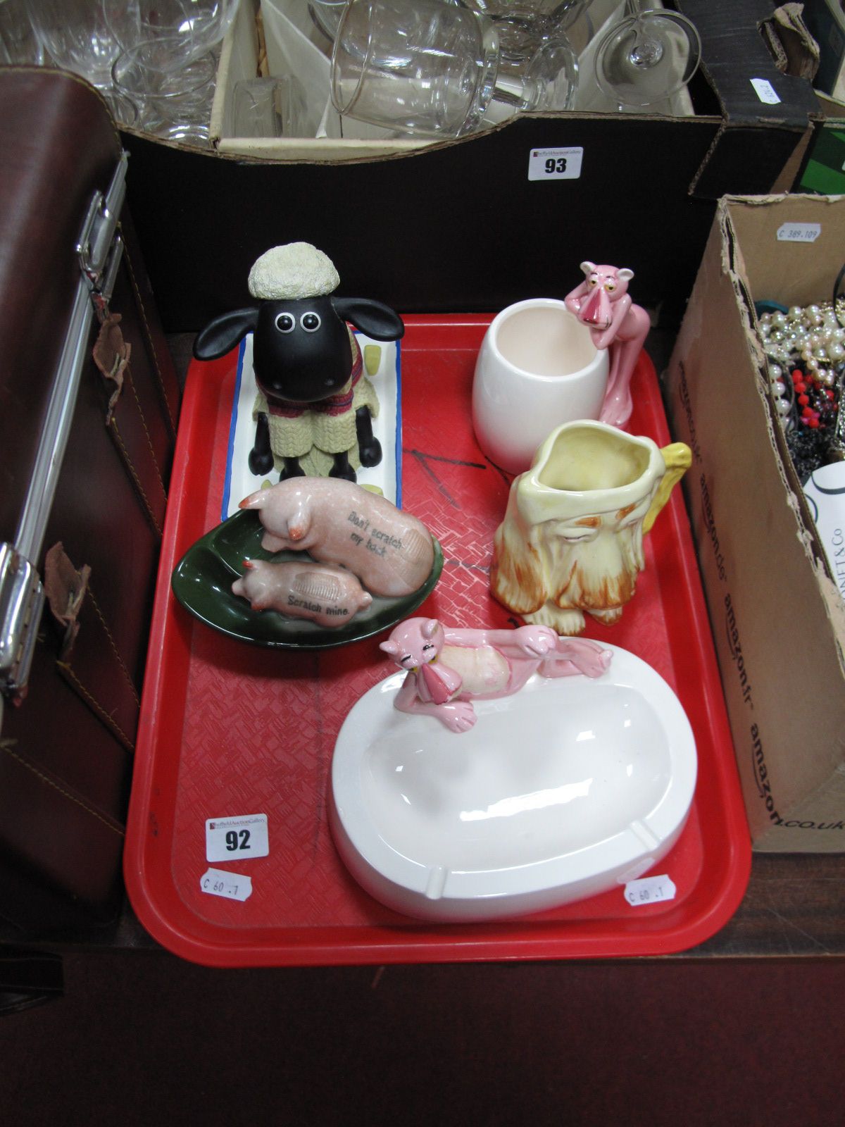 An Early XX Century Novelty Matchstriker, formed with two pigs, a UA "Pink Panther" mug and ashtray,