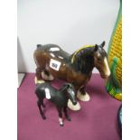 A Royal Doulton Shire Horse, together with a Royal Doulton foal.