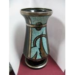 An Art Deco Black Glass Pedestal Vase, with silvered bands and abstract cloud on mottled blue panel,