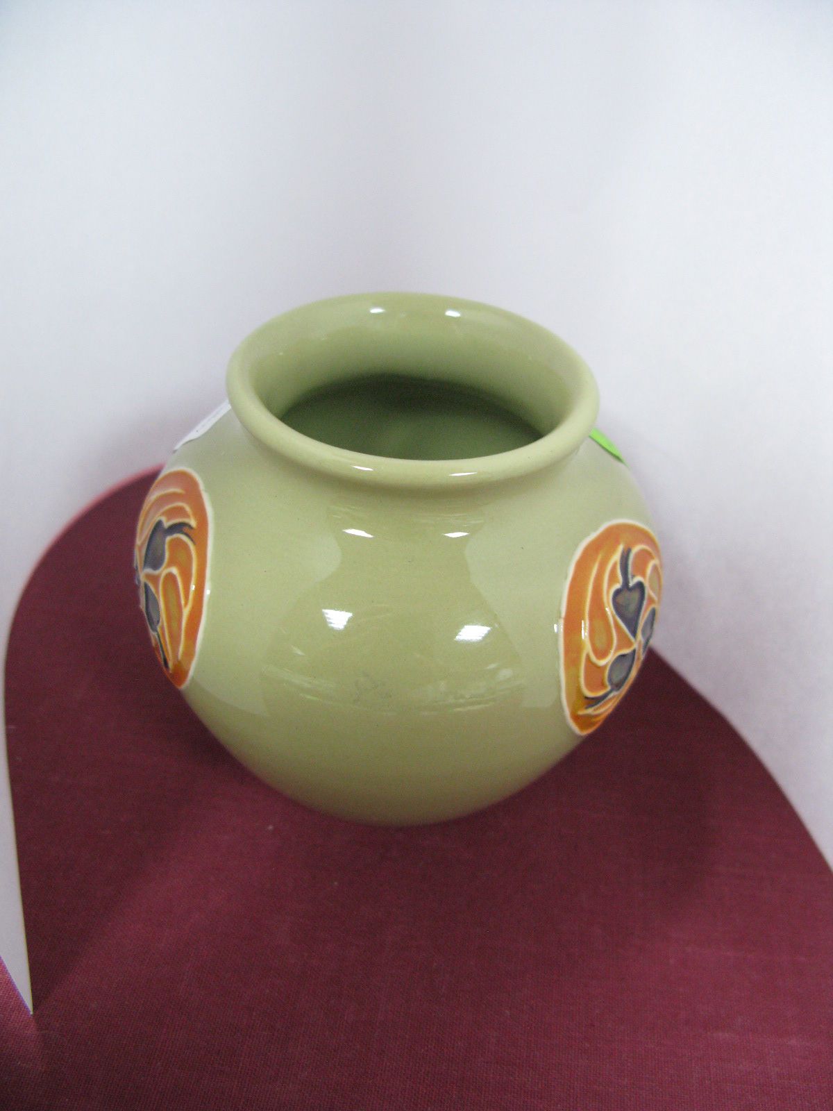 A Moorcroft Vase in the Flamminian Design, on a celadon ground, impressed and painted marks to