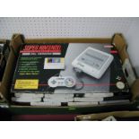 A Boxed Super Nintendo Entertainment System, with ten game cartridges, including Mystical Ninja,