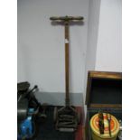 An Early XX Century Push-a-Long Grass Cutter, of narrow proportions, wheels cast 'Eden Foreign'