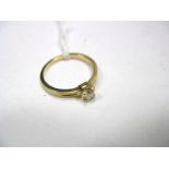 An 18ct Gold Princess Cut Single Stone Diamond Ring, corner set between textured shoulders.
