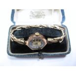 A 9ct Gold Cased Lady's Wristwatch, on expanding bracelet, stamped "9ct", in a fitted case.