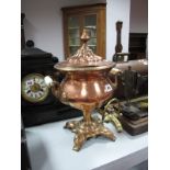 A XIX Century Copper and Brass Tea Urn, with a turned finial, twin handles, brass tap, on quatrefoil