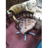 A Button Back Tan Leather Captain's Chair, with close studded decoration on modern five star base.