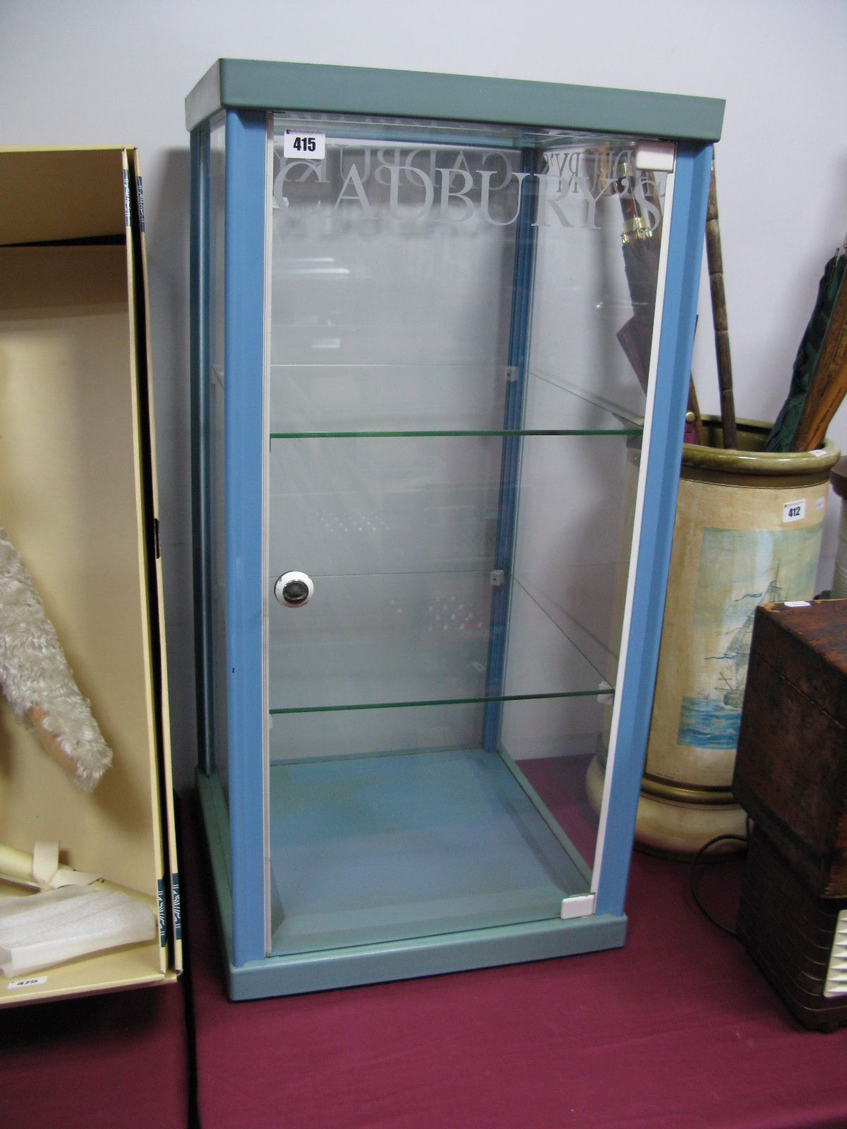 A Mid XX Century Revolving Shop Counter Display Cabinet, with two glass internal shelves, labelled