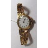 A 15ct Gold Cased Lady's Wristwatch, the white dial with black and red Arabic numerals, within plain