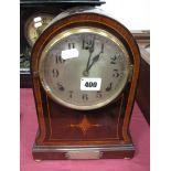 An Edwardian Dome Topped Mantel Clock, having silvered dial with Arabic numerals on plinth base,