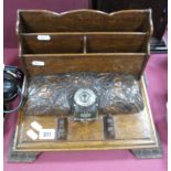 A Late XIX Century Oak Stationery Stand, having envelope stand behind carved panel, central
