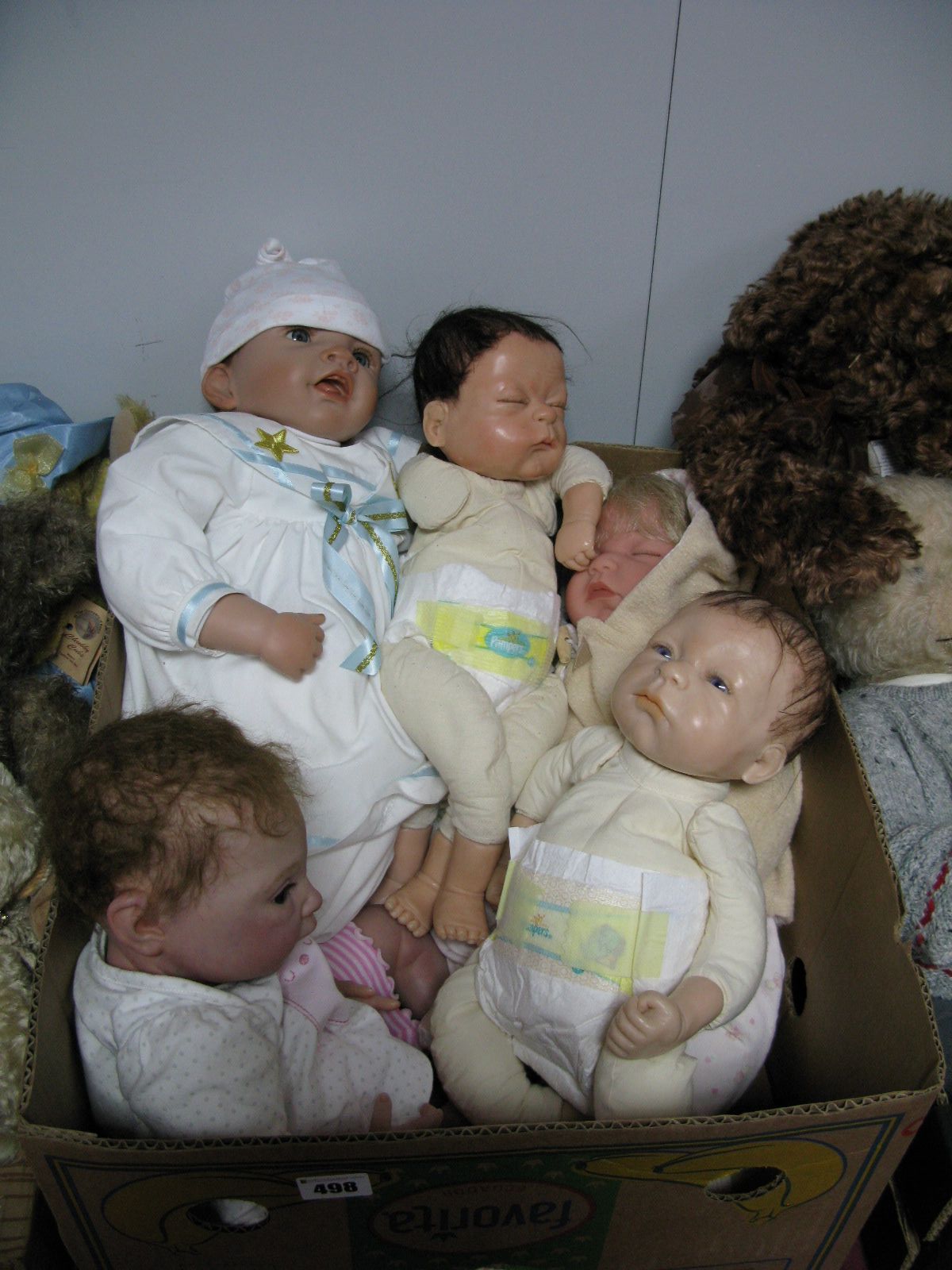 A Reborn Doll, in polka dot jumpsuit, together with two Anna Carter dolls, an Ashton Drake artists