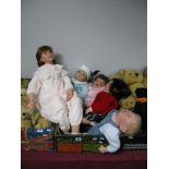 A Reborn Doll, wearing powder blue jumper, together with three Middleton collectable dolls, plus