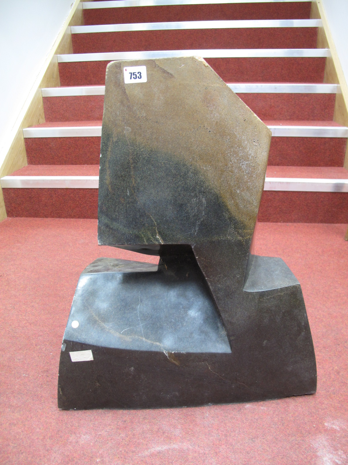 A Variegated Stone Sculpture, of abstract form, 60.5cms high.