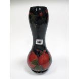 A Moorcroft Pottery Vase, of double gourd form, tube lined and painted in the Pomegranate pattern on