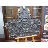 A Carved Oak Wall Panel or Pediment, of shaped arched form, centrally relief carved with a mask