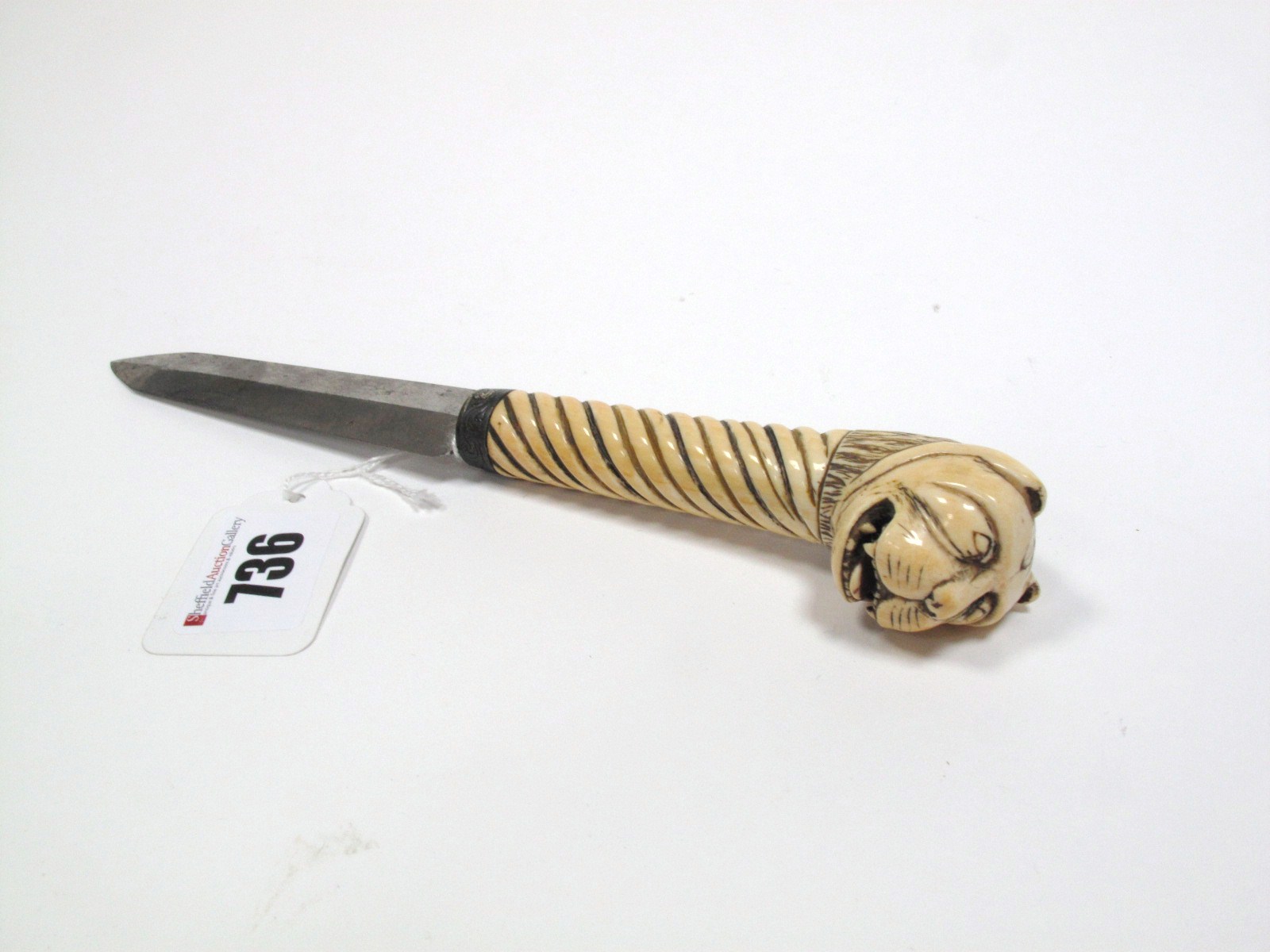 A Late XIX Century Knife, with twin edge blade, length 11.3cms, foliate engraved tine and carved