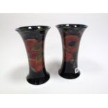 A Pair of Moorcroft Pottery Vases, of waisted cylindrical form, tube lined and painted with the