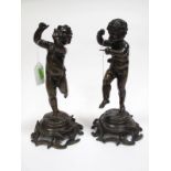 A Pair of XX Century Cast Bronze Figures of Putti, one playing a triangle, the other a flute (both