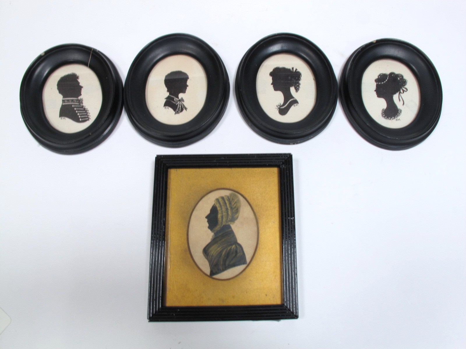 A Victorian Bronzed Silhouette Portrait of a Woman, oval, 8.2 x 6.2cms, reeded, ebonised frame; Four
