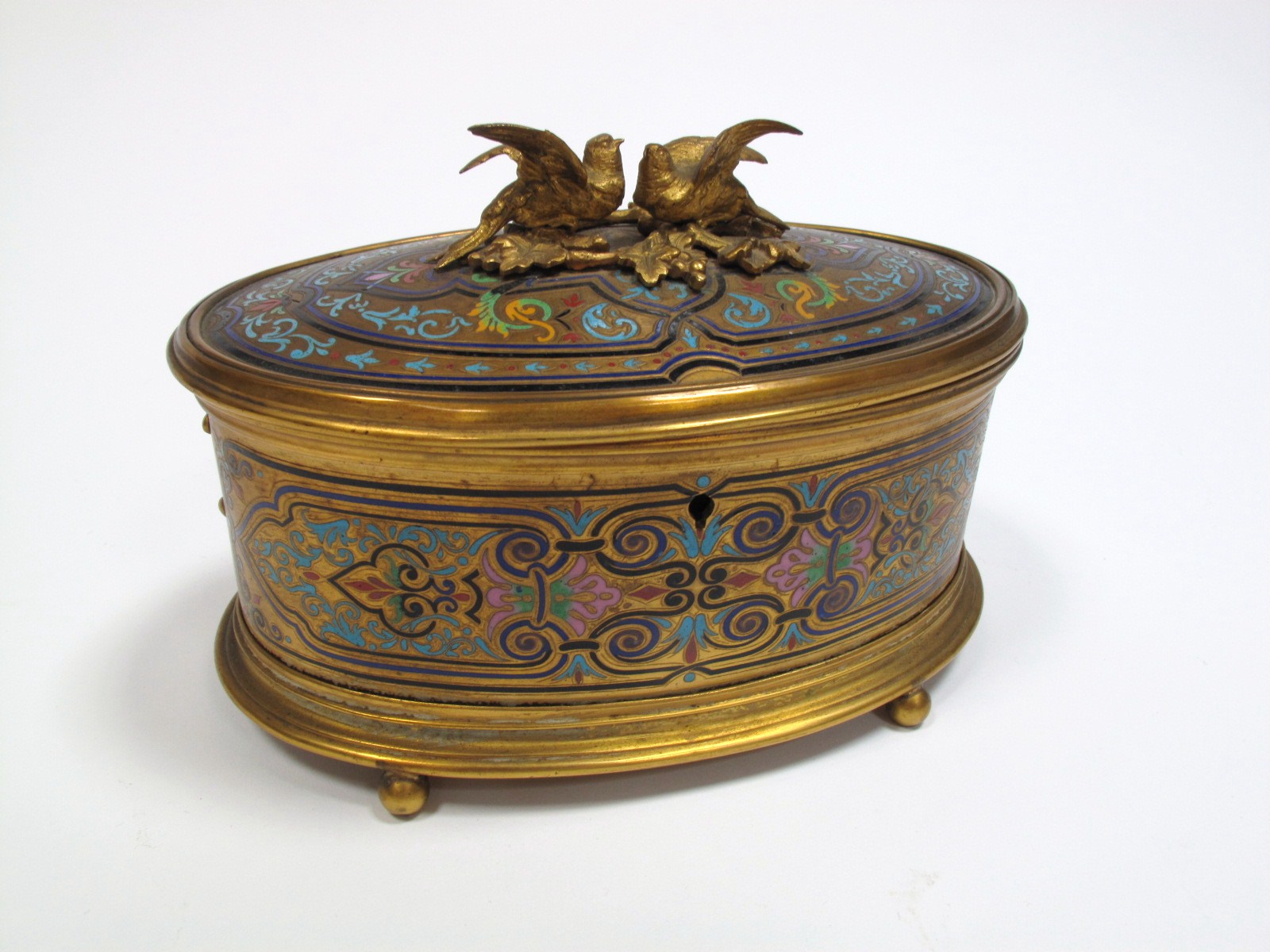 An Early XX Century French Bronze and Champleve Enamel Oval Jewel Casket, internally velvet lined,